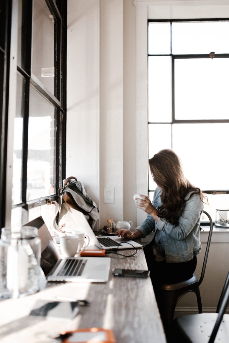 woman sitting at desk in front of computer