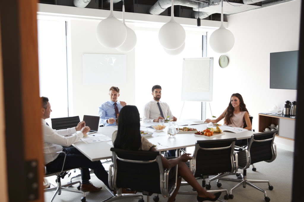 businessmen-businesswomen-meeting-modern-boardroom-working-lunch-scaled
